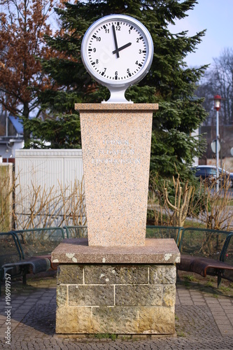 Normaluhr (standard clock) in Magdeburg in Germany. The inscription means Learn, Create, Be happy photo