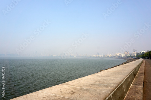 Marine drive or Queen's necklace,The road links Nariman Point to Babulnath and Malabar Hill. A promenade lies parallel to this road. Back Bay is part of the Arabian Sea. Mumbai India Asia. smog smoke