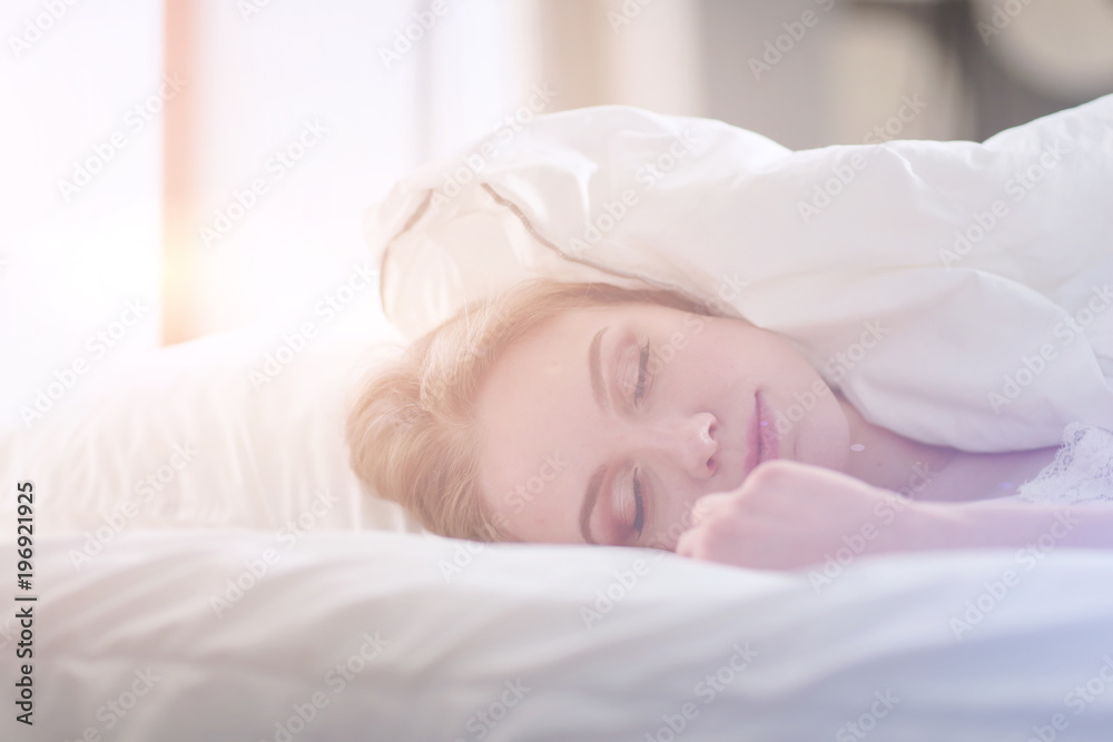 Pretty woman lying down on her bed at home Pretty woman lying down on her bed at home