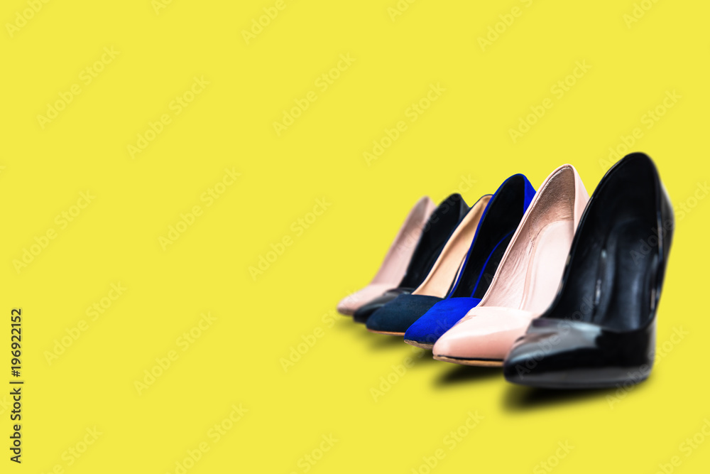 High heels footwear on a yellow pastel 