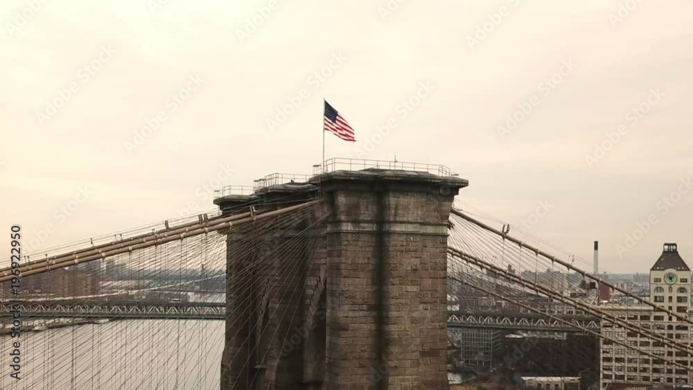 aerial circling Brooklyn Bridge with beautiful colorful sky in New York City NYC in 1080 HD