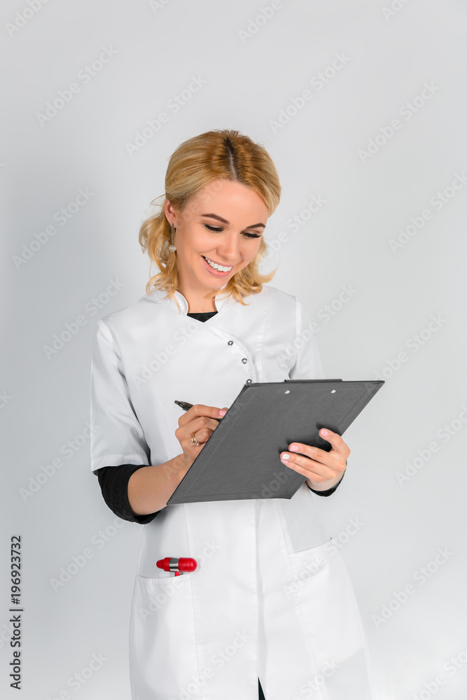 A female doctor with a folder, standing on white background A female doctor with a folder, standing on white background