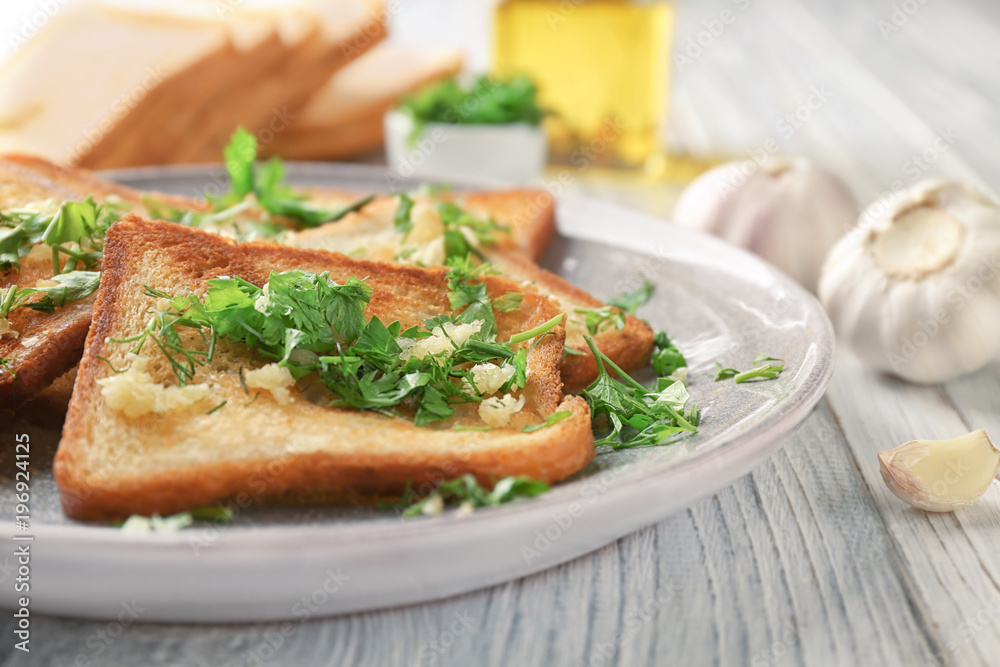 Plate with delicious homemade garlic bread on table Plate with delicious homemade garlic bread on table