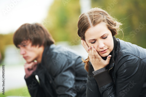Relationship trouble or problem. Depressed woman and man in park