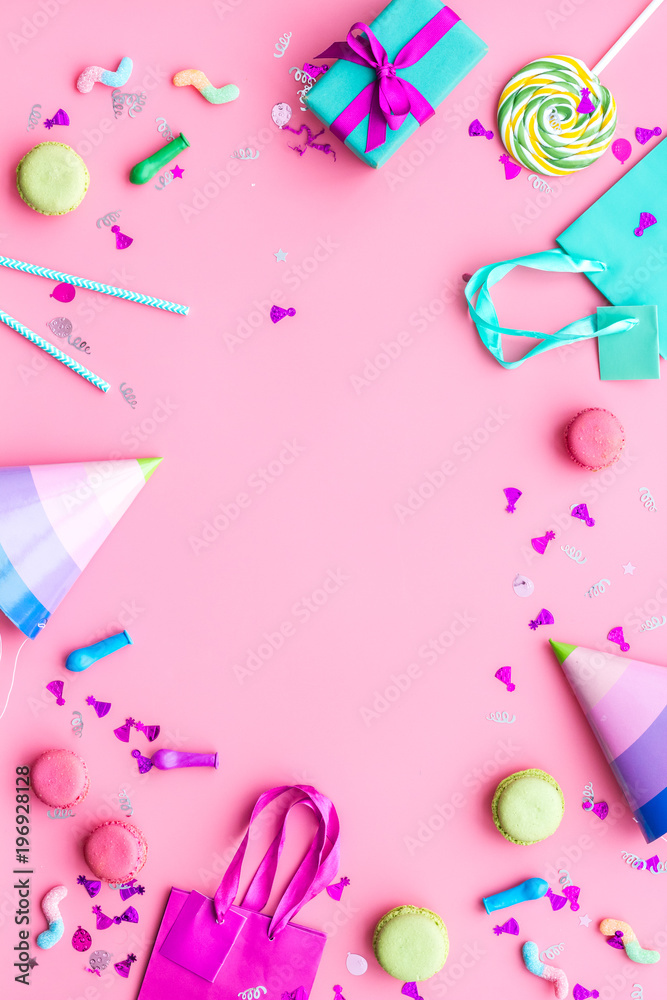 Gift concept. Sweets, paper bag for gift on pink background top view copy space Gift concept. Sweets, paper bag for gift on pink background top view copy space