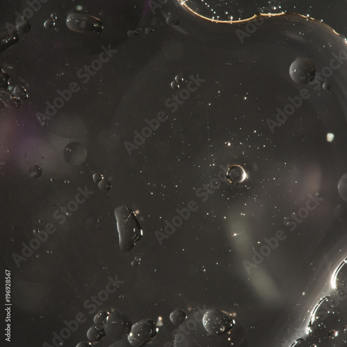 drops of water on the surface of the oil, variation of dissimilar liquids, macro abstract background