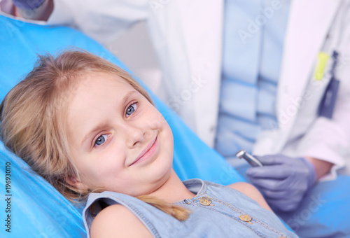 Little girl sitting in the dentists office