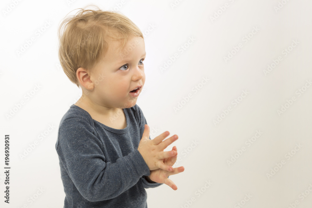 Surprised baby boy isolated on white background. Cute toddler with asking face expression. Adorable kid asking what is going on. Copy space Surprised baby boy isolated on white background. Cute toddler with asking face expression. Adorable kid asking what is going on. Copy space