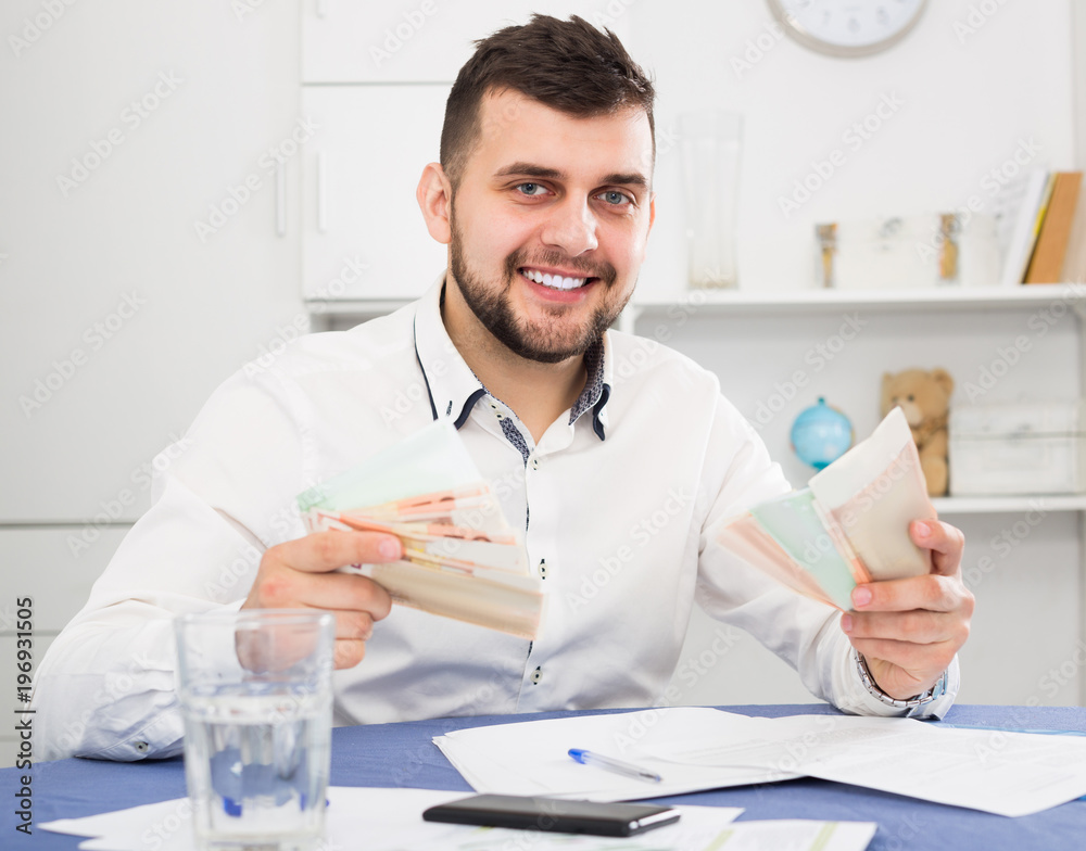 Male worker earning money effectively online