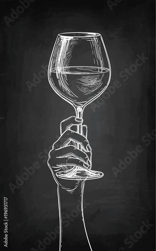 Hand holding a glass of wine.