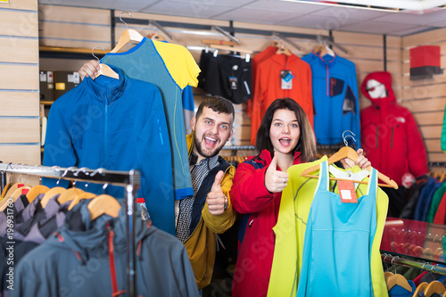 Couple demonstrating sportswear in store