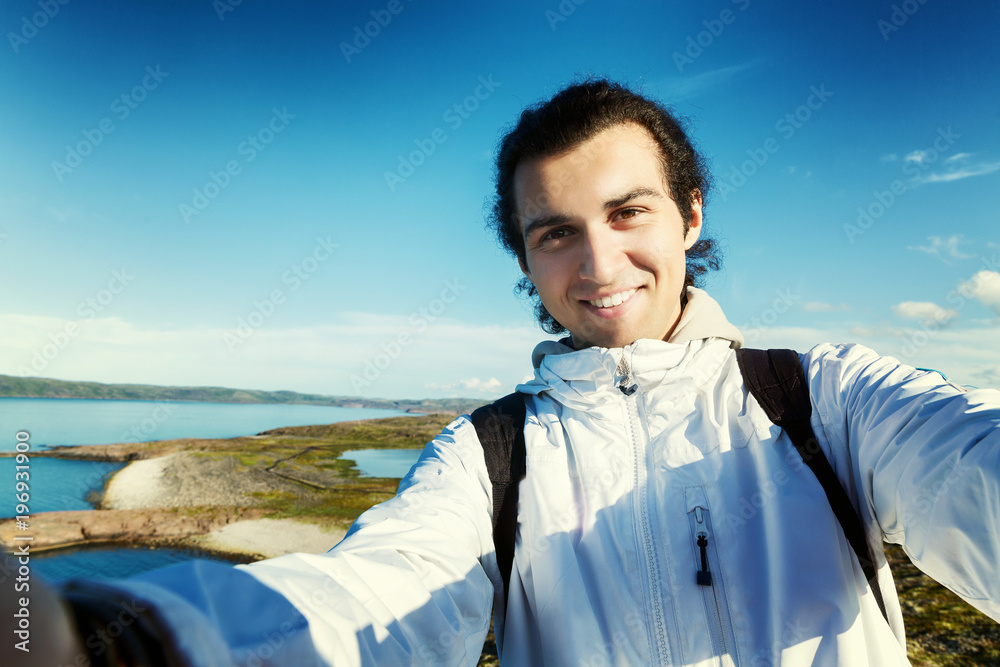 A handsome young man is photographed in a beautiful landscape A handsome young man is photographed in a beautiful landscape