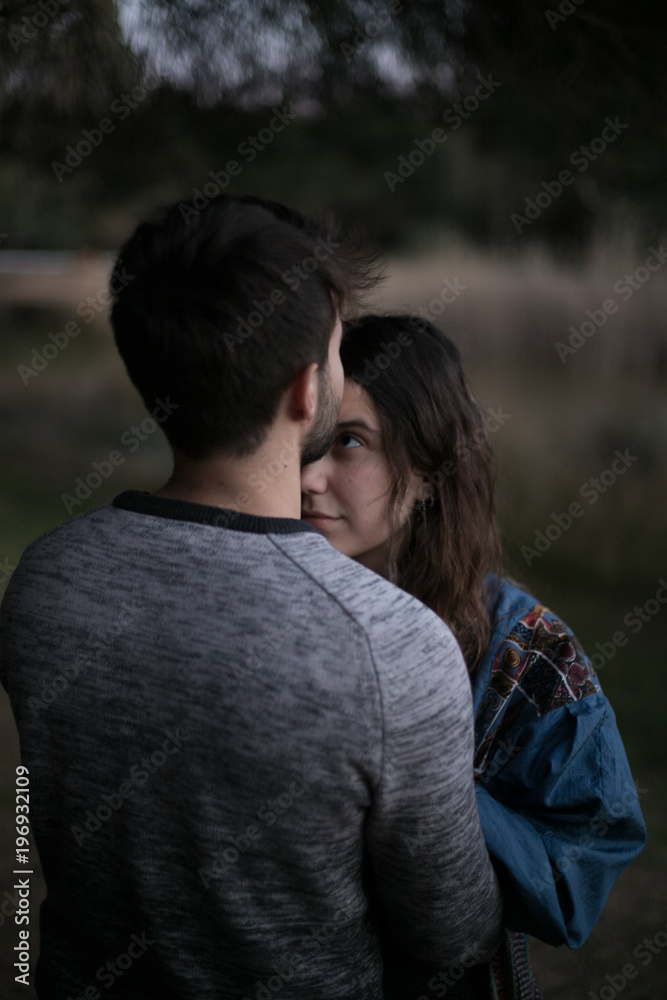 A cute spanish couple having a nice afternoon hugging and kissing each other in a park in front of a lake in Seville, Spain. A cute spanish couple having a nice afternoon hugging and kissing each other in a park in front of a lake in Seville, Spain.