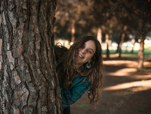 An attractive girl having fun in a sunny day inside a park in Seville, Spain.