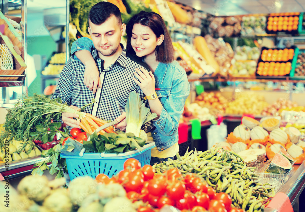 Guy and girl are deciding on vegetables