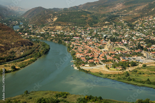 Top view on the Mtskheta city and the Aragvi river confluence with mountains on the background. Georgia 2017.