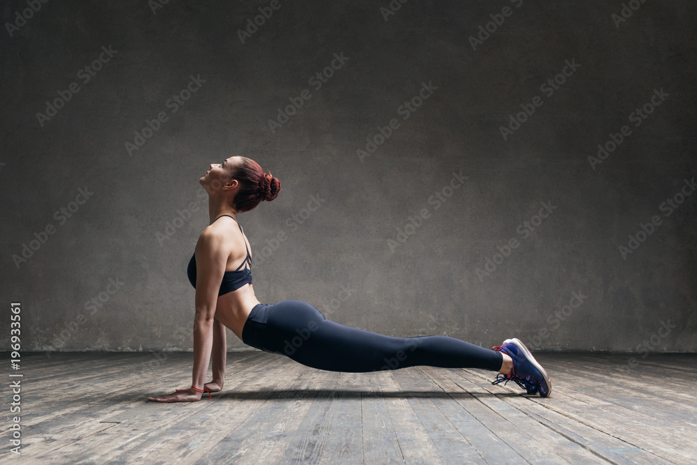 Young beautiful athlete is posing in studio