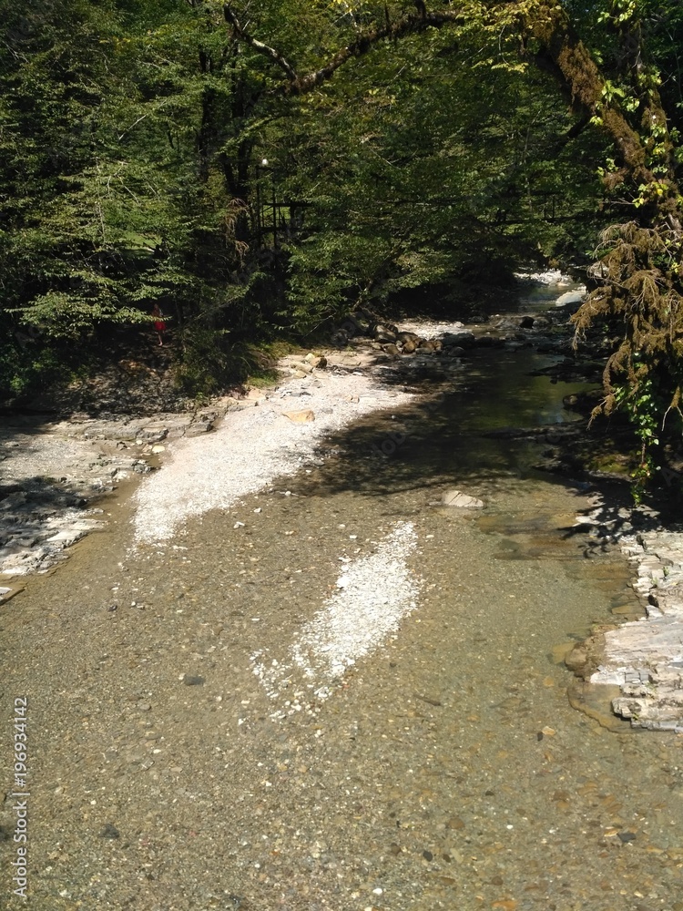 Mountain stream is washed by sharp rocks of the mountain