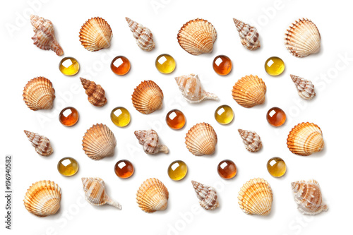 Pattern made of shells and orange glass beads isolated on white background