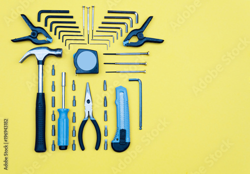 Set of tools. Home improvement concept on yellow background.