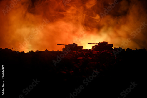 War Concept. Military silhouettes fighting scene on war fog sky background  World War German Tanks Silhouettes Below Cloudy Skyline At night. Attack scene. Armored vehicles. Tanks battle. Close up