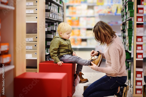 Cute little boy during shopping with his young mother photo