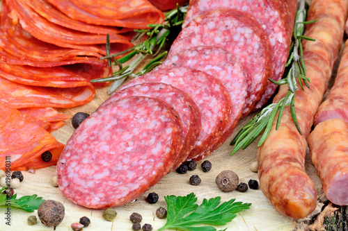 Sliced of chorizo, salami and sausages with spices on table