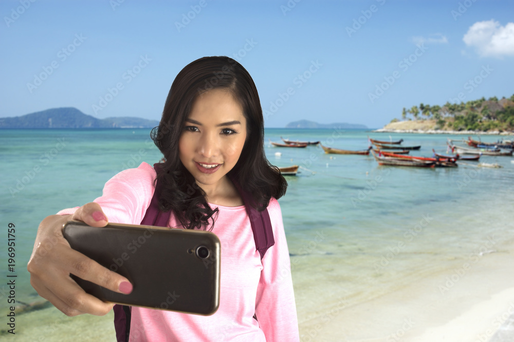 Tourist girl take selfy photo with beautifule sea.