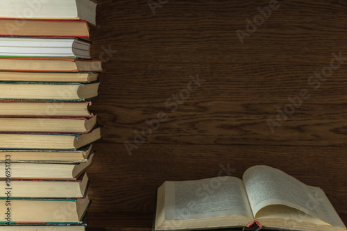 old books on a wooden shelf. stacked one on the other. background. open book.