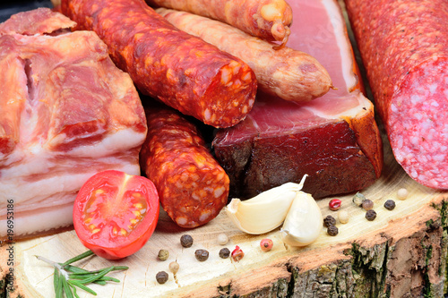 Variety types of sausages on a wood board