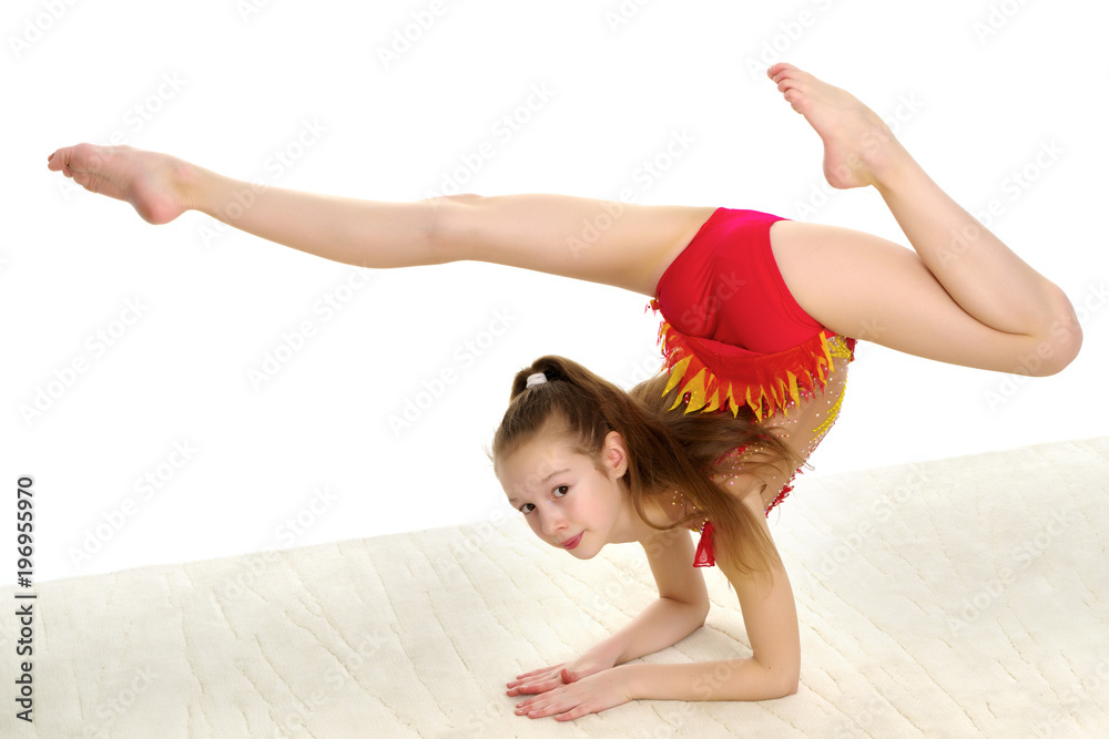A gymnast performs an exercise stance on her forearms. A gymnast performs an exercise stance on her forearms.