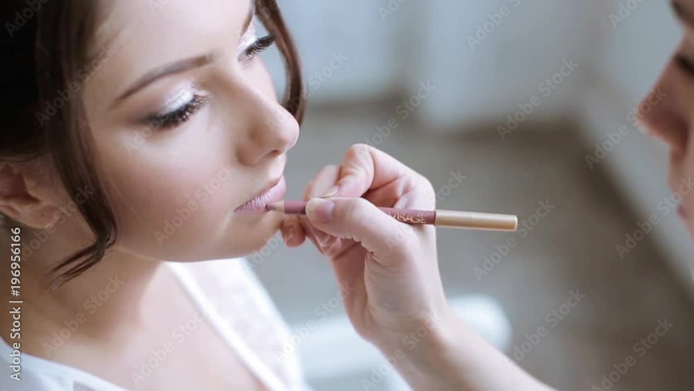 Wedding makeup artist making a make up for bride Wedding makeup artist making a make up for bride