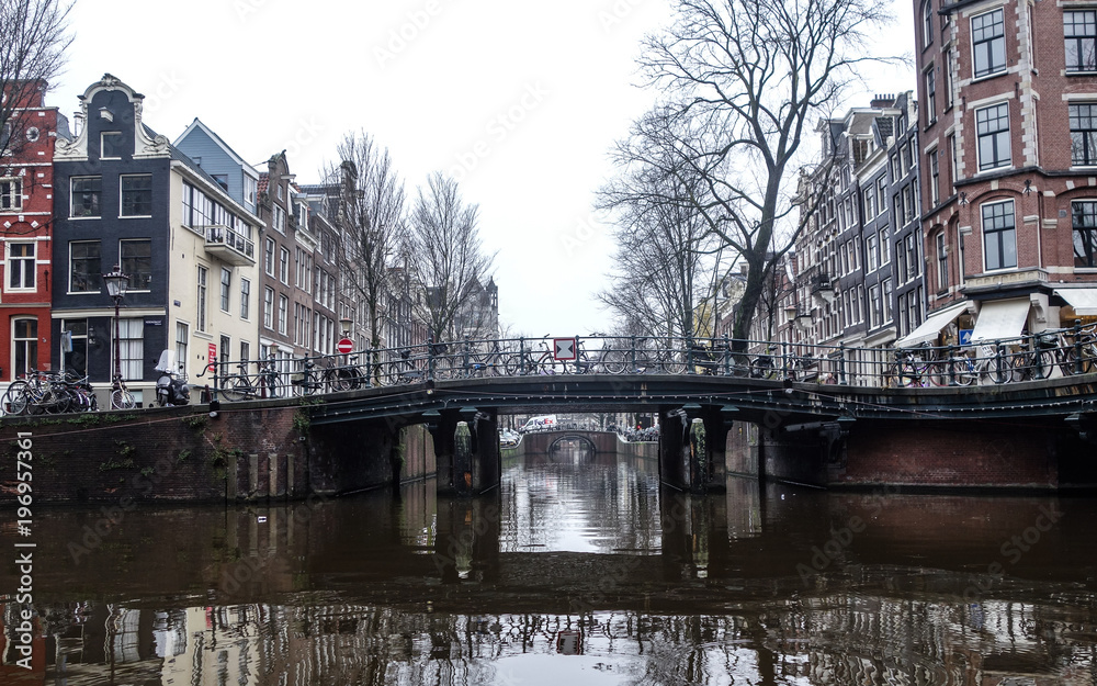 Dec 20, 2017 - Bridge over Amsterdam canal on a misty winter day