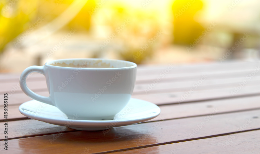 white cups with hot espresso on wood table and nature light white cups with hot espresso on wood table and nature light