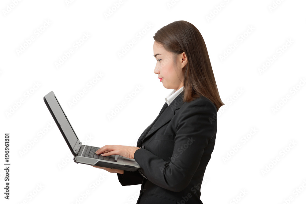 young business woman, standing wearing a white shirt and black suit holding a laptop pc. young business woman, standing wearing a white shirt and black suit holding a laptop pc.