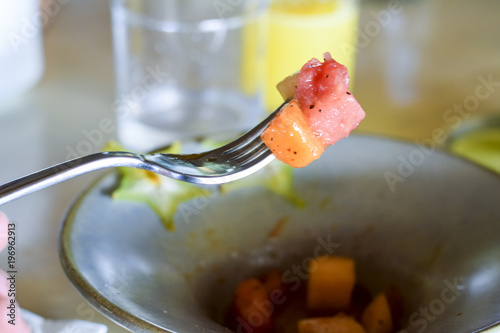 Fruit salad pieces on a fork photo