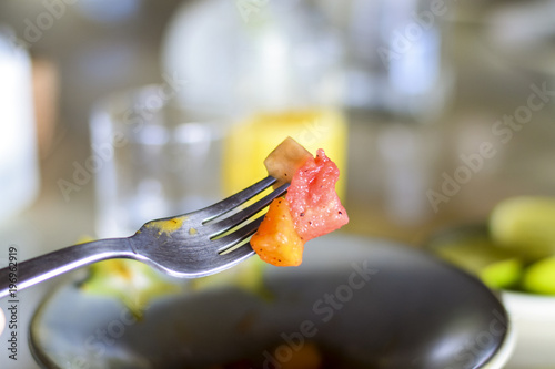 Fruit salad pieces on a fork photo
