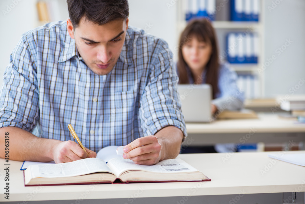 Students sitting and studying in classroom college