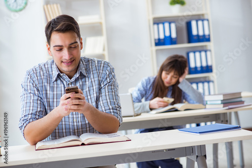 Students sitting and studying in classroom college