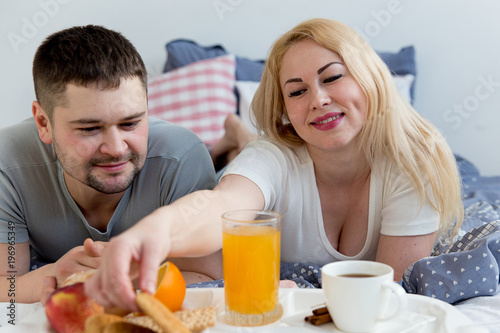 Couple enjoying breakfast in bed