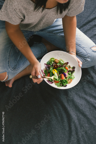Top view woman eating salad top view Healthy food © kucherav