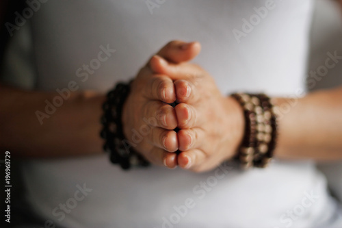 Woman hand yoga pose. Practicing meditation and praying indoors.