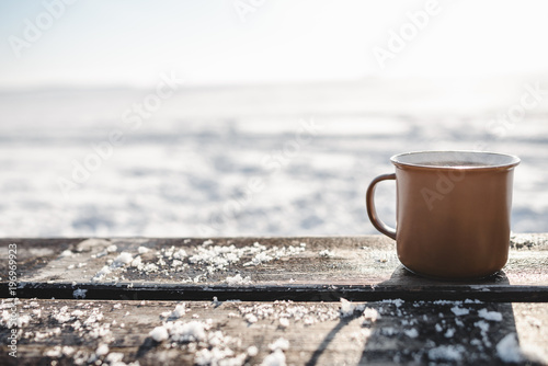 Cup of tea on the wooden table outdoors