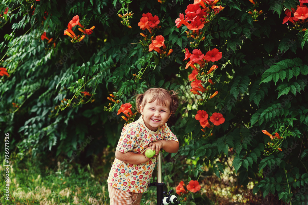 Cheerful little girl on a walk on a summer day