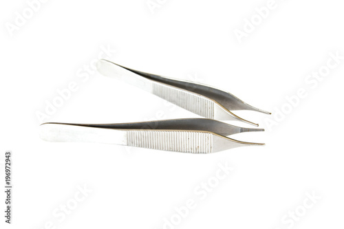 Surgical Instruments (tweezers, pliers, clamp the blade, scalpel, scissors) on a white table.
