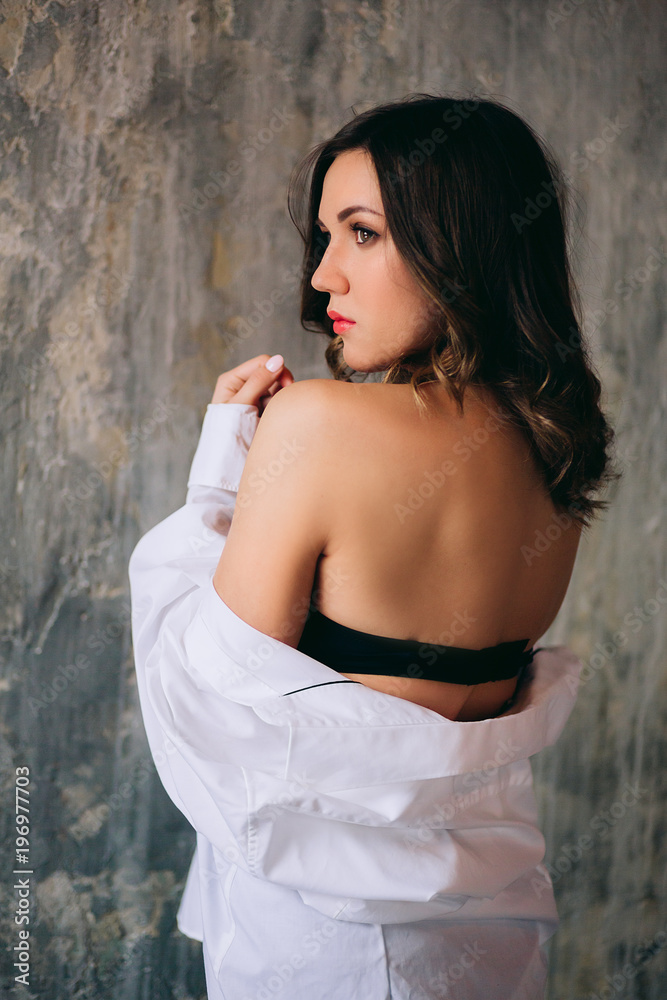 Obraz premium Beautiful girl-brunette in lingerie and white shirt