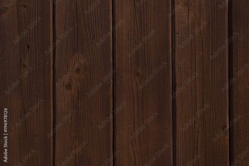 Dark brown vertical boards - wooden background Dark brown vertical boards - wooden background