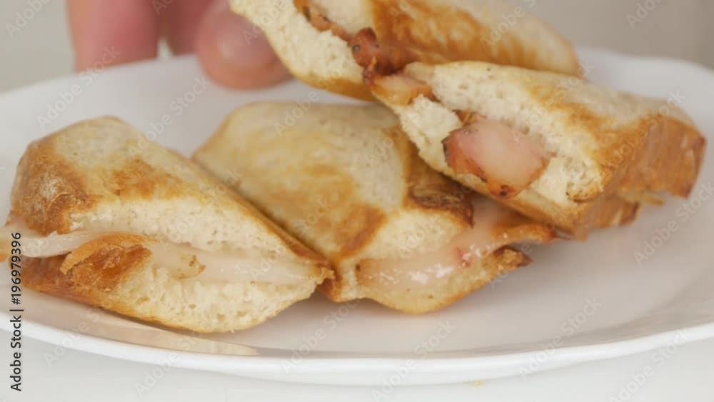 Man Arranging a Plate with Hot and Tasty Grilled Sandwiches on the Table Man Arranging a Plate with Hot and Tasty Grilled Sandwiches on the Table