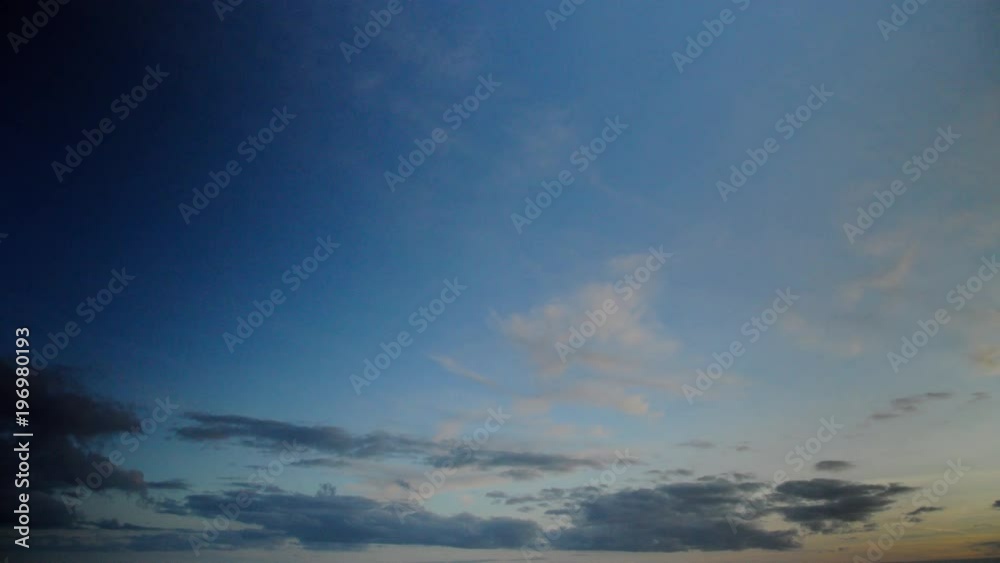 Timelapse with clouds gradually filling the sky from left to right at the gates of dawn. The colors change from dark blue and azure to light pink and mauve.