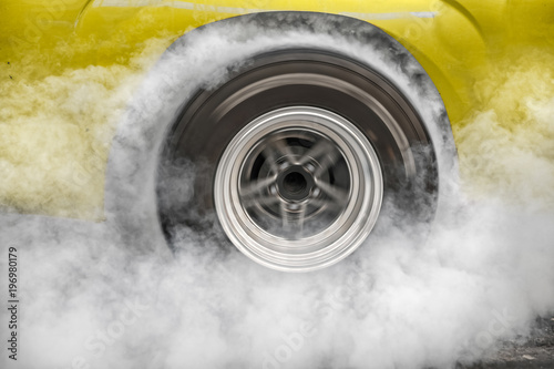 Drag racing car burns rubber off its tires in preparation for the race © toa555